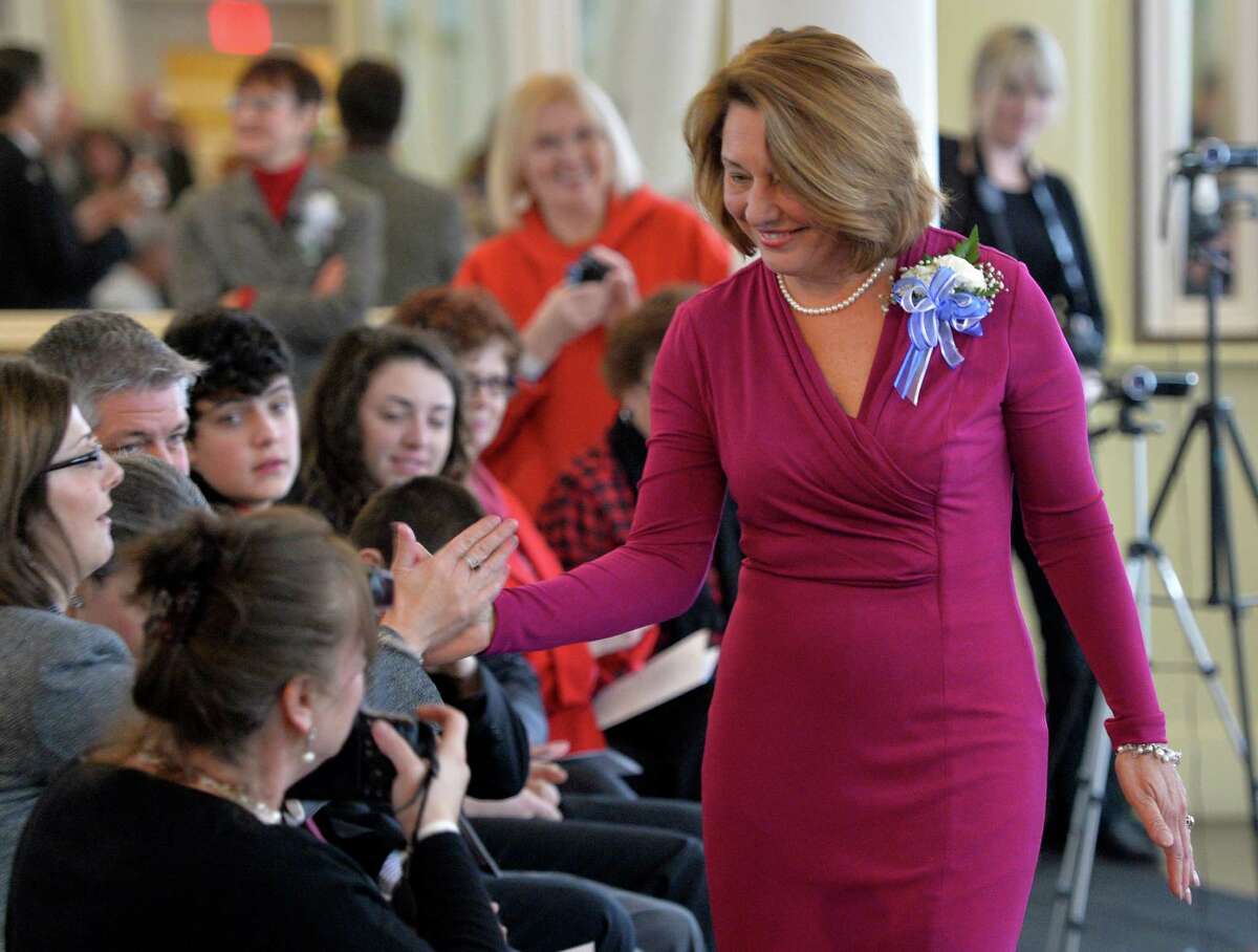 Saratoga Springs Mayor Joanne Yepsen gets some hi fives from the crowd after being sworn in Wednesday afternoon Jan. 1, 2014 in the Canfield Casino in Saratoga Springs, N.Y. (Skip Dickstein / Times Union)
