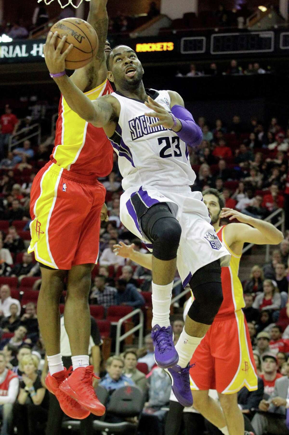 Sacramento Kings guard Marcus Thornton (23) lays the ball up over Houston Rockets forward Terrence Jones during the first period of an NBA basketball game, Tuesday, Dec. 31, 2013, in Houston. (AP Photo/Patric Schneider)