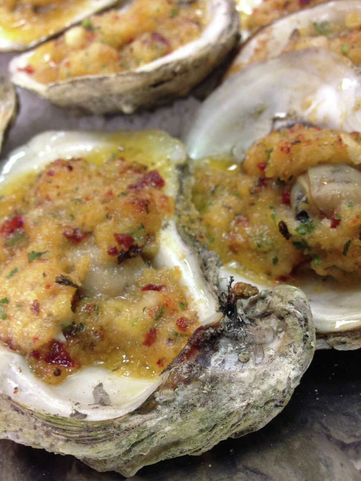 Ostiones Asados -- wood-roasted Gulf oysters with chipotle butter from Caracol, Houston.