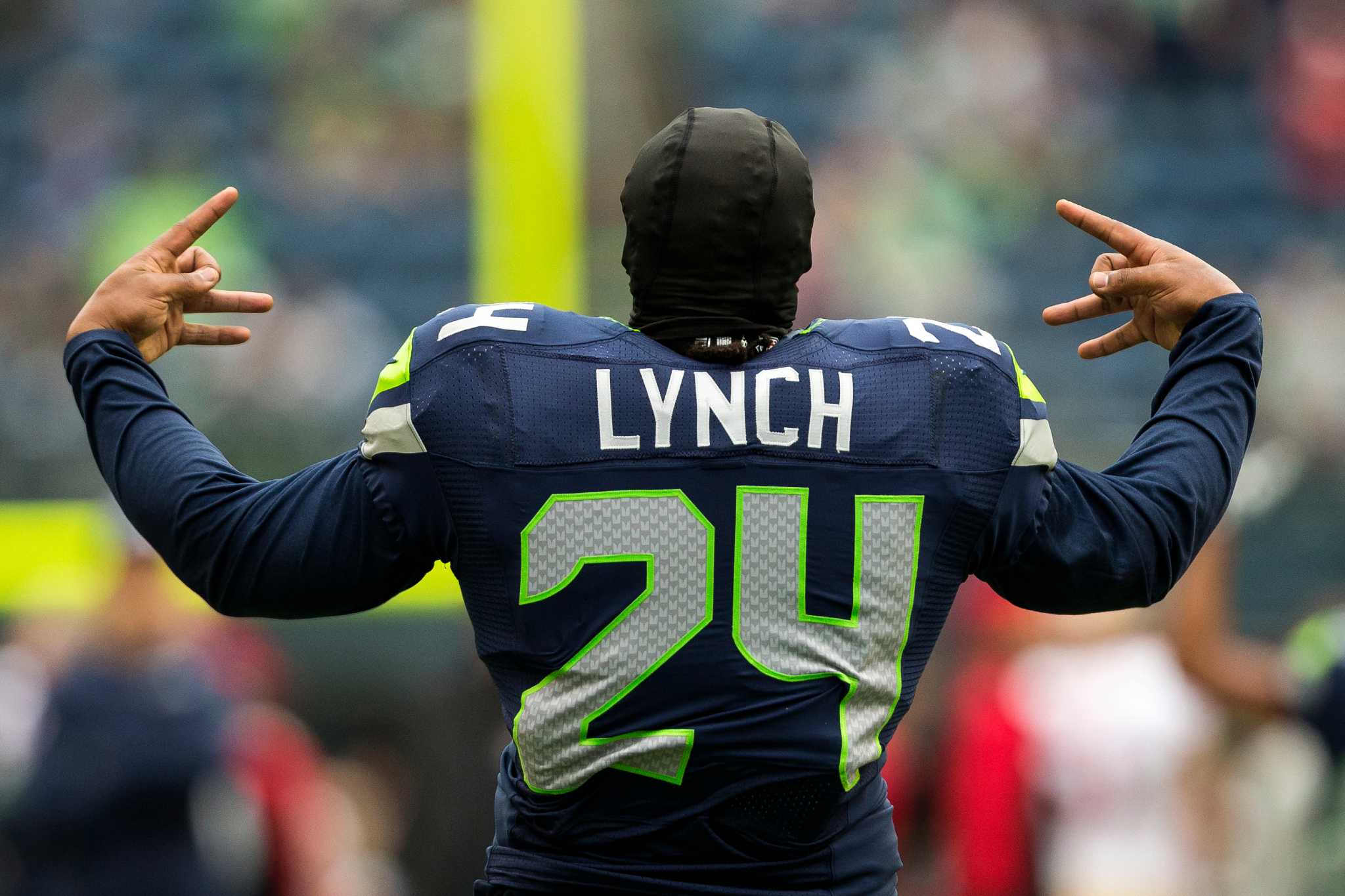 Seattle Seahawks running back Marshawn Lynch (24) beat a drum as