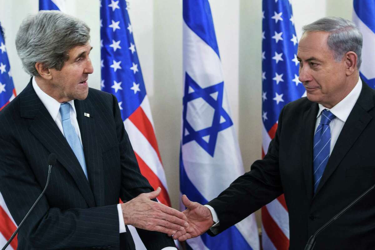U.S. Secretary of State John Kerry, left, and Israeli Prime Minister Benjamin Netanyahu shake hands before a meeting at the prime minister's office in Jerusalem, Thursday, Jan. 2, 2014. Kerry arrived Thursday in Israel to broker Mideast peace talks that are entering a difficult phase aimed at reaching a two-state solution between the Israelis and Palestinians. (AP Photo/Brendan Smialowski, Pool)
