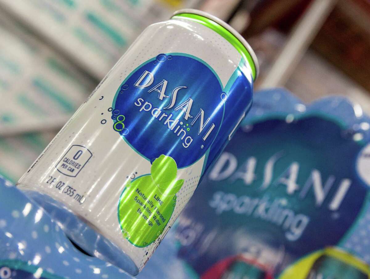 Sam's Club, 10488 Old Katy Road. Mark Milton, Club Manager, arranges a display of Coca Cola's Dasani Sparkling Water. 1/02/14 (Craig H. Hartley/For the Chronicle)
