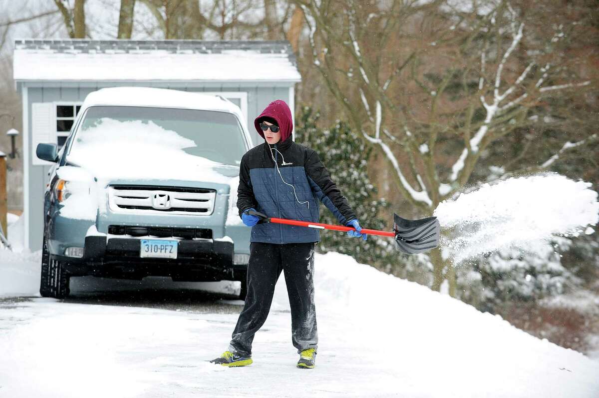 Cameron Thomas shovels his Tuckahoe Lane driveway after an overnight storm dumped about 6 inches of snow in Fairfield, Conn. on Friday, Jan. 3, 2014.