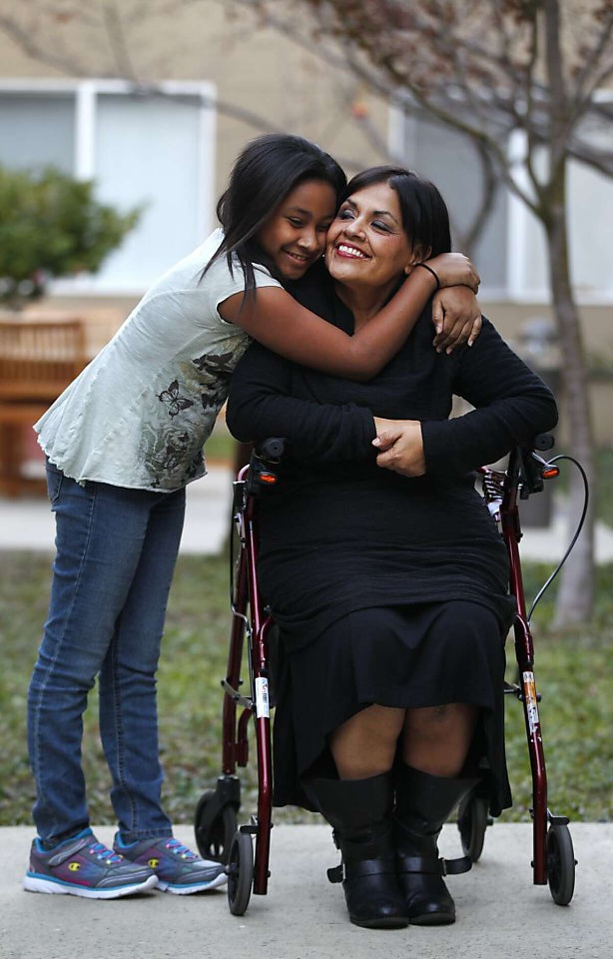 Mary Trejo, 50, right, pictured with her daughter Maryana Brooks, 10, at their new home in the Borregas Court Apartment complex December 26, 2013 in Sunnyvale, Calif. Trejo and her daughter became temporarily homeless after she was injured on the job during core training at the Santa Clara County Juvenile Hall in 2011 and was then unable to work and thus unable to make her house payments. Trejo recently had a full knee replacement after re-injuring herself earlier this fall when she fell down a flight of stairs.