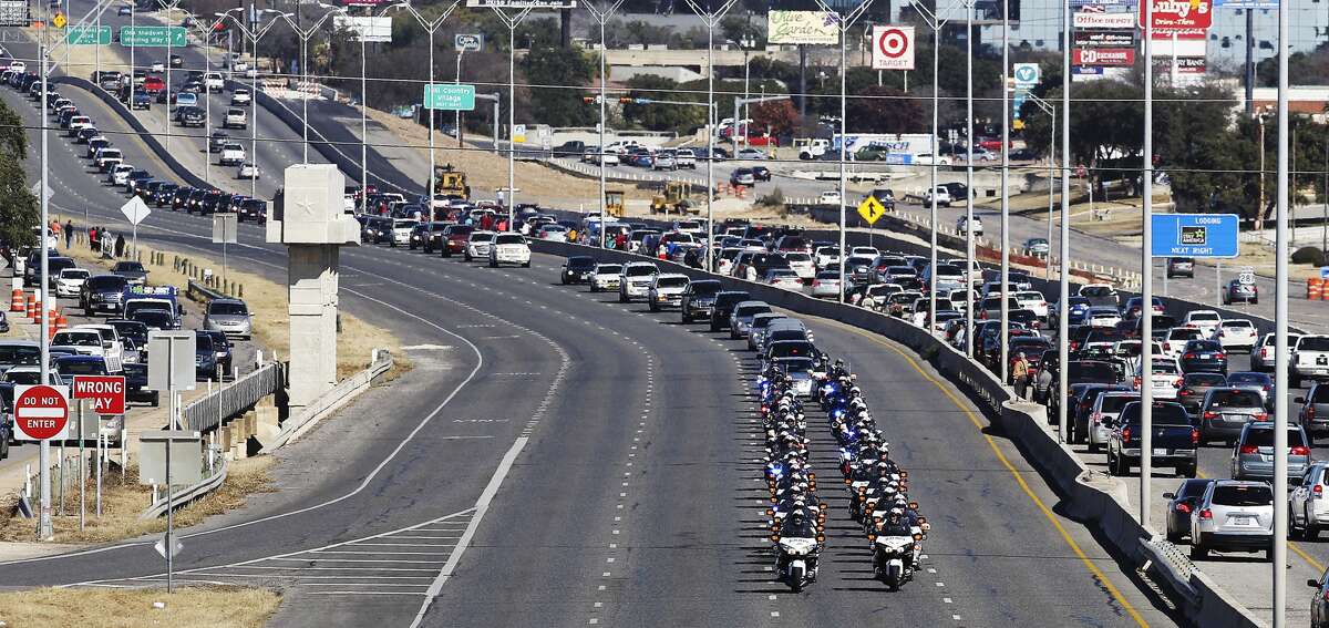 A procession for fallen San Antonio police officer Robert Deckard is led by SAPD motorcycles on Saturday, Jan. 4, 2014. Deckard was shot when in pursuit of two armed robbery suspects on Dec. 8 and died 13 days later. Family, friends and fellow police officers gathered at Cornerstone Church for a service and then a large procession went to Deckard's final resting place at Mission Park South.