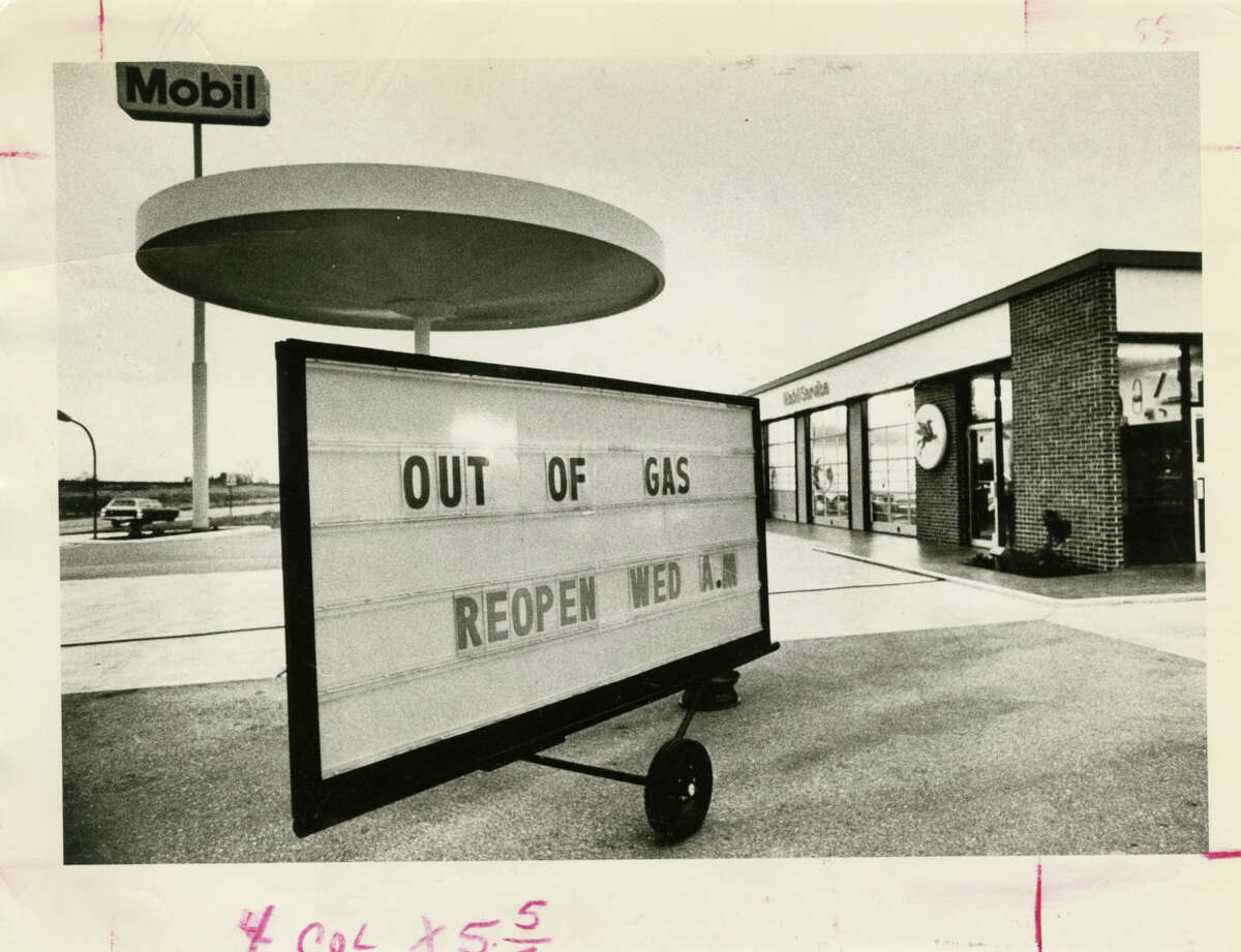 Motorists hoping to fill up on New Year's Eve in 1973 were greeted by locked pumps and an "OUT OF GAS" sign at this service station on U.S. 290. Four decades later, the problem is too much oil.