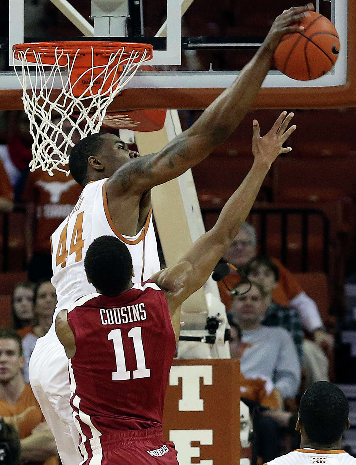 Texas center Prince Ibeh swats a shot away from Isiah Cousins as the Longhorns play Oklahoma in the Erwin Center on January 4, 2014.