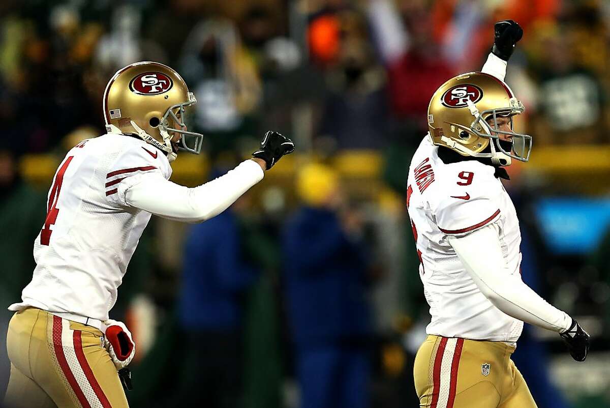GREEN BAY, WI - JANUARY 05: Phil Dawson #9 of the San Francisco 49ers celebrates with teammate Andy Lee #4 after kicking 33 yard field goal to defeat the Green Bay Packers in their NFC Wild Card Playoff game at Lambeau Field on January 5, 2014 in Green Bay, Wisconsin. The San Francisco 49ers defeated the Green Bay Packers 23-20. (Photo by Jonathan Daniel/Getty Images)