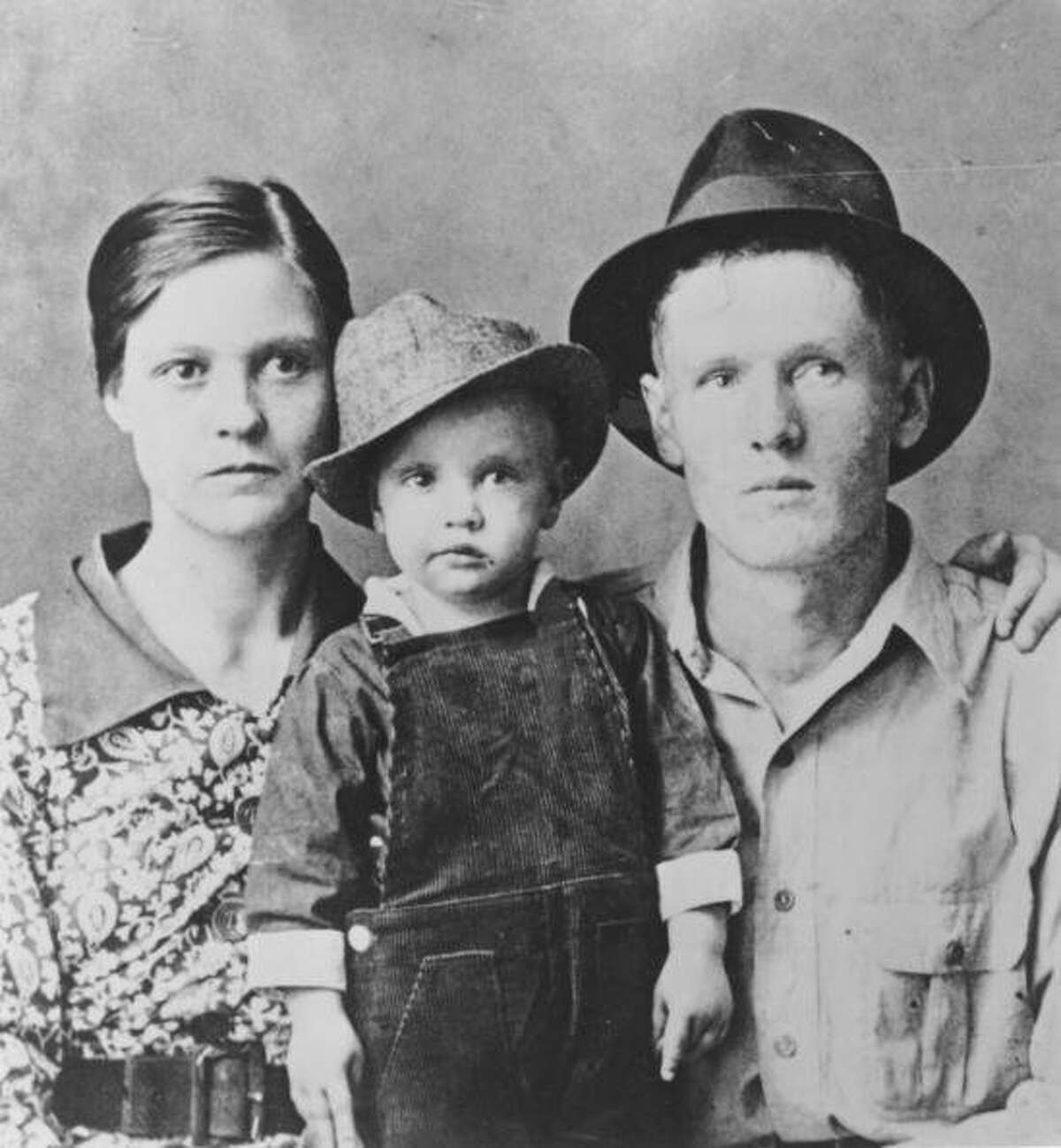 Rock and roll singer Elvis Presley poses for a family portrait with his parents Vernon Presley and Gladys Presley in 1937 in Tupelo, Mississippi. (Photo by Michael Ochs Archives/Getty Images)