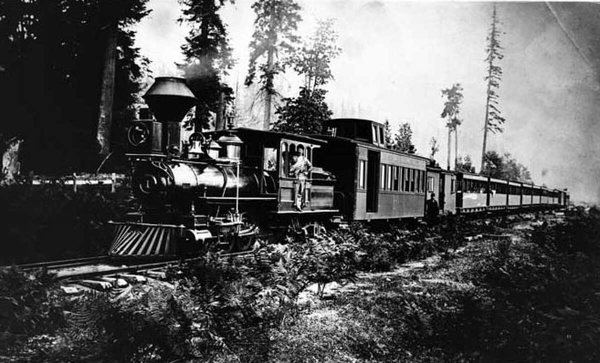 1880: Seattle's first railroad. Pictured above, a locomotive takes a load of passengers to the Georgetown racetrack. Webster & Stevens photo. Photo id 1983.10.6275. To order a reproduction or to inquire about permissions contact photos@mohai.org or phone 206-324-1126.