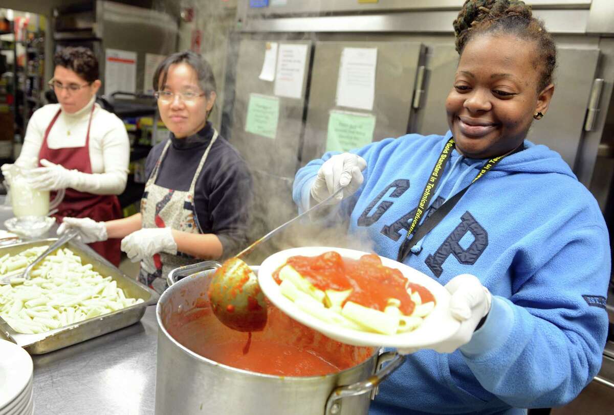 Tacarra Lawrence, of West Haven, a Medical Assisting student at Platt Tech, serves dinner with other students and teachers from the program Tuesday, Jan. 7, 2013 for guests at the Beth-El Center in Milford, Conn. Platt Tech has established a partnership with the Beth-El Center in Milford. Volunteers from the school will now be cooking and serving dinner at the soup kitchen on the first Tuesday of every month.