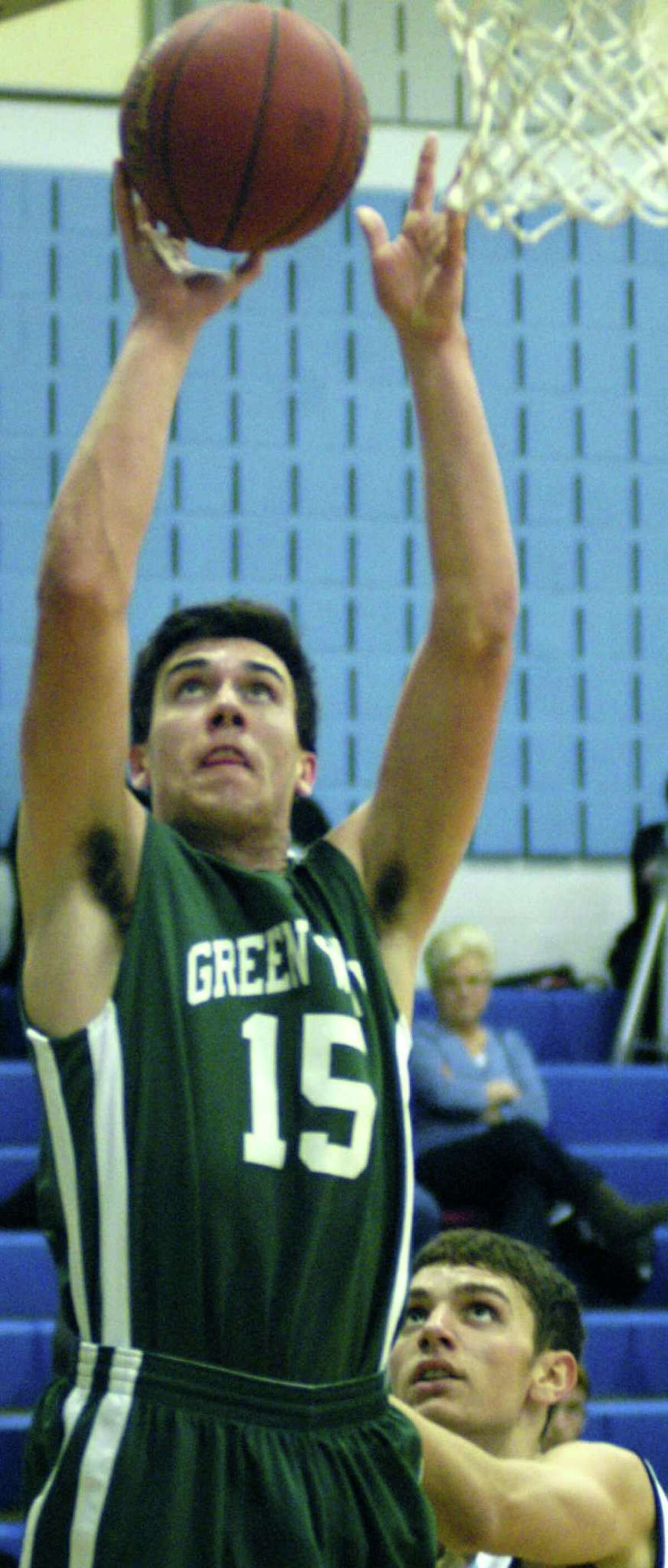 Drew Hansen of the Green Wave elevtaes to score two points during New Milford High School boys' basketball's 57-38 victory over host Oxford, Jan. 4, 2014.