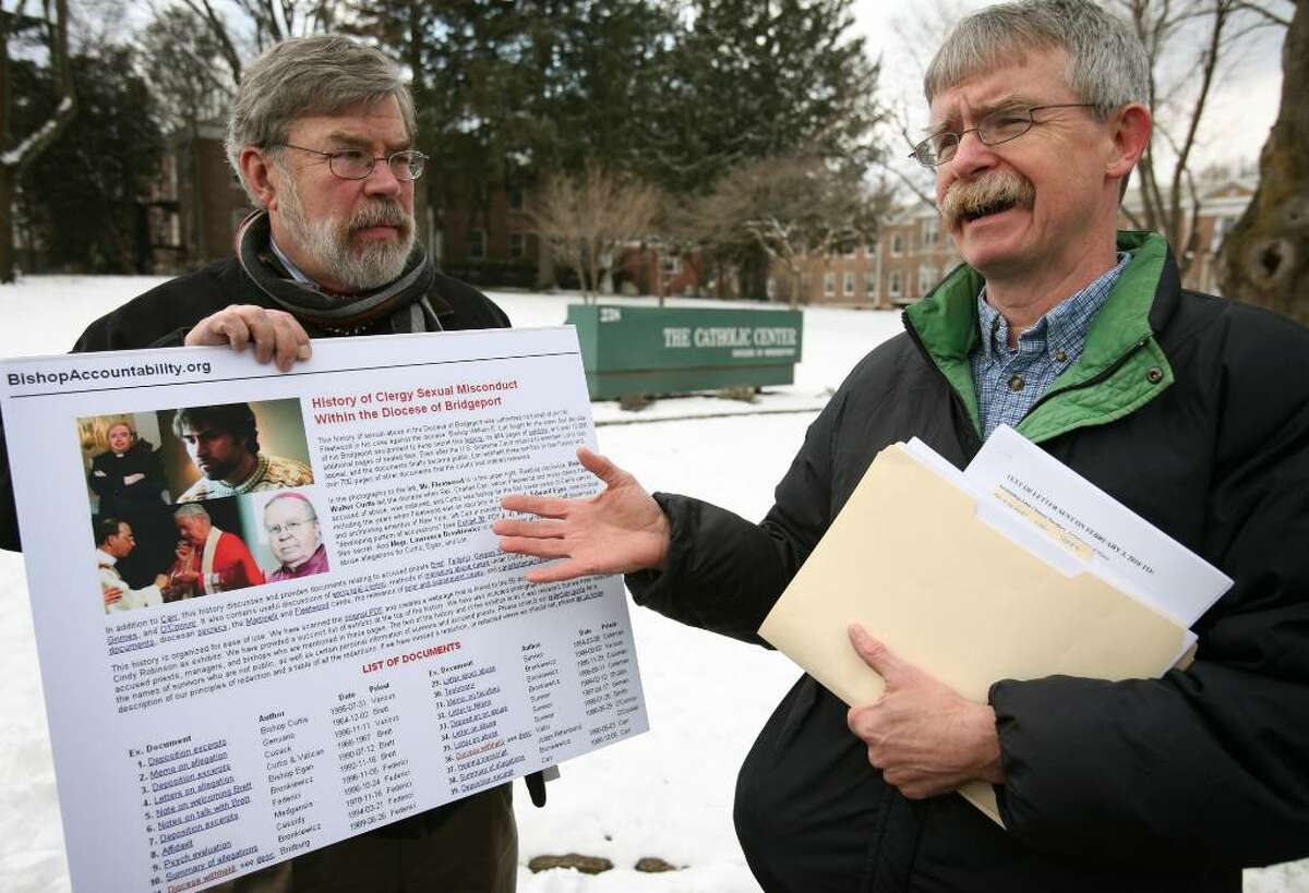Voice of the Faithful board member John Marshall Lee, left of Bridgeport, and co-director of BishopAccountability.org Terry McKiernan of Natick, MA, protest outside the Catholic Center on Jewett Avenue in Bridgeport on Wednesday, February 3, 2010.