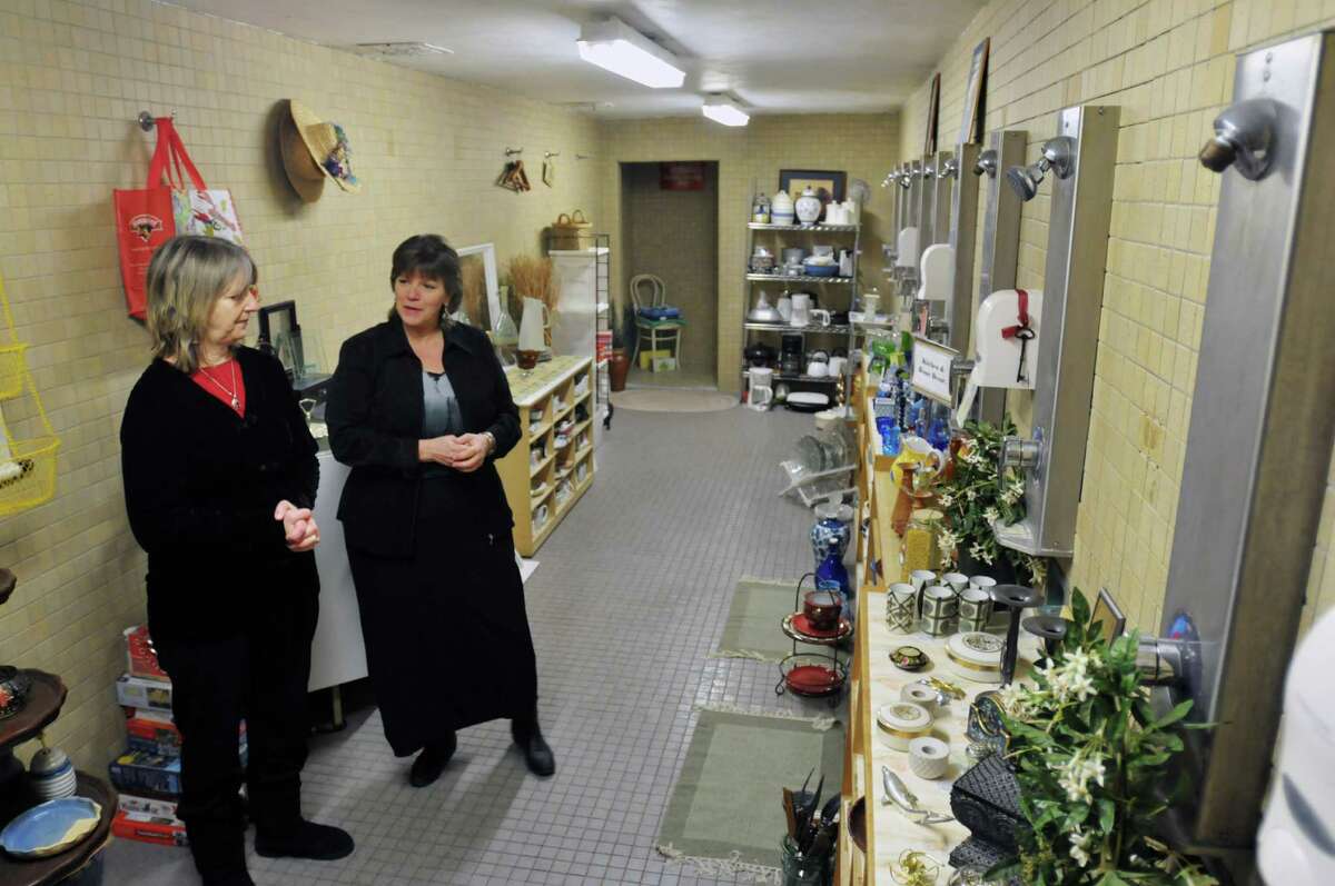 Mary Partridge-Brown, left, and Roberta Sandler with Grassroot Givers show off the shower area at the former YMCA building that they have turned into a housewares boutique on Tuesday, Jan. 7, 2014 in Albany, NY. (Paul Buckowski / Times Union)