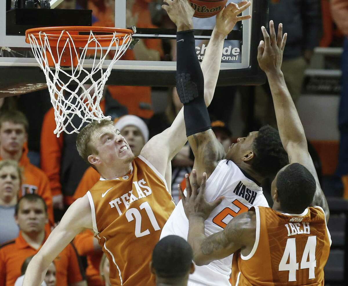Texas' Connor Lammert (left) blocks a shot by Oklahoma State's Le'Bryan Nash during the first half in Stillwater. Lammert scored 11 points in the Longhorns' loss.