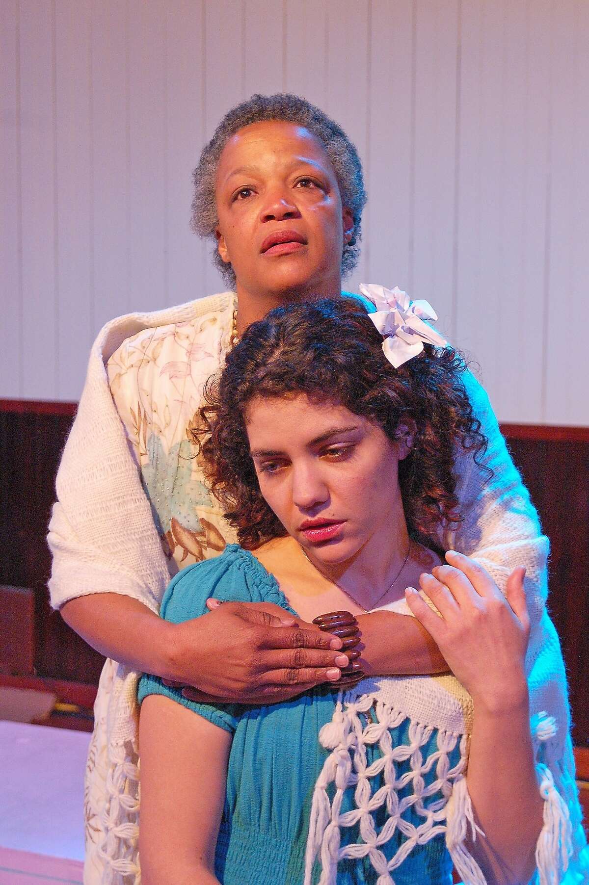 Senhora Costa (Cathleen Riddley, rear) comforts daughter Helena (Carla Pauli) on the eve of her sister's wedding in Alter Theater's "The River Bride"