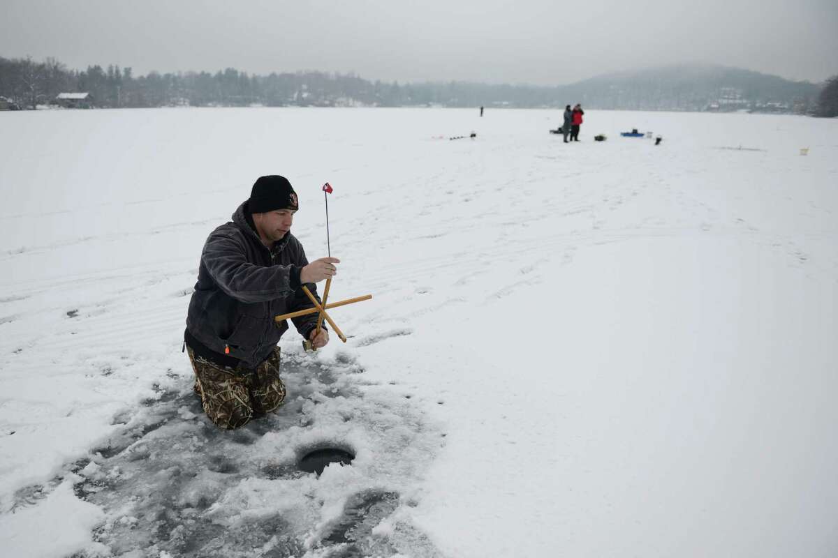 Fish under their feet in icetopped lake