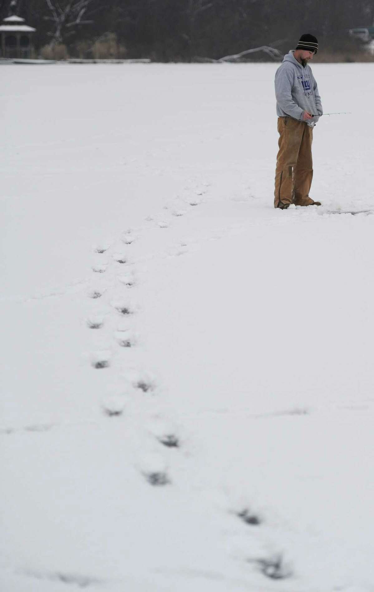 Fish under their feet in icetopped lake