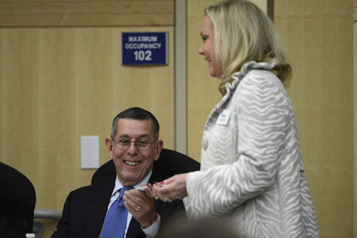 South San ISD's interim superintendent Abelardo Saavedra accepts business cards from Marian Strauss of Executive Search Services during a board meeting on Thursday, Jan. 9, 2014. Attorney Pablo Escamilla sits at left. Strauss and her group are tasked with conducting a nationwide search for a permanent superintendent for the district.