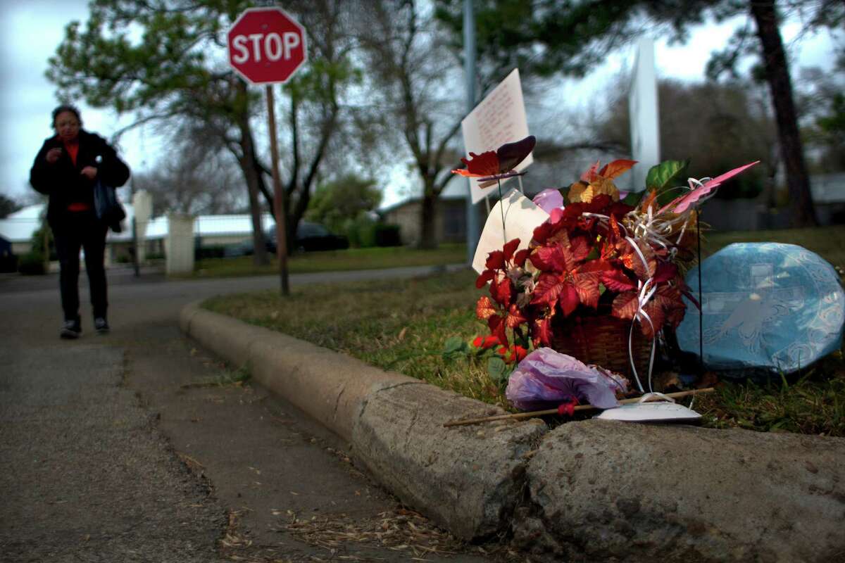 A woman approaches a memorial for Christina Bell Burleson, 43, who was attacked and died from wounds after being mauled by two female pit bulls on the corner of Glen Prairie near Leonora Wednesday, Jan. 8, 2014, in Houston. The woman, who did not want to be identified, said that she was friends with Burleson and her loss is tragic. "She was a real person, she just wasn't someone on the streets." Burleson died around 2 a.m. Sunday. ( Johnny Hanson / Houston Chronicle )
