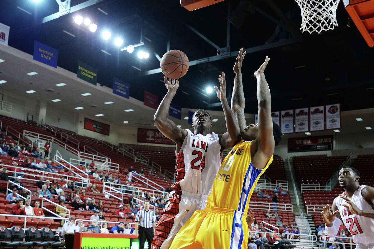 Lamar Cardinals Ocatavius Green, No. 24, left, drives the ball in during Saturday's game against McNeese State Cowboys at the Montagne Center. Michael Rivera/@michaelrivera88 Photo taken Saturday, 01/11/14