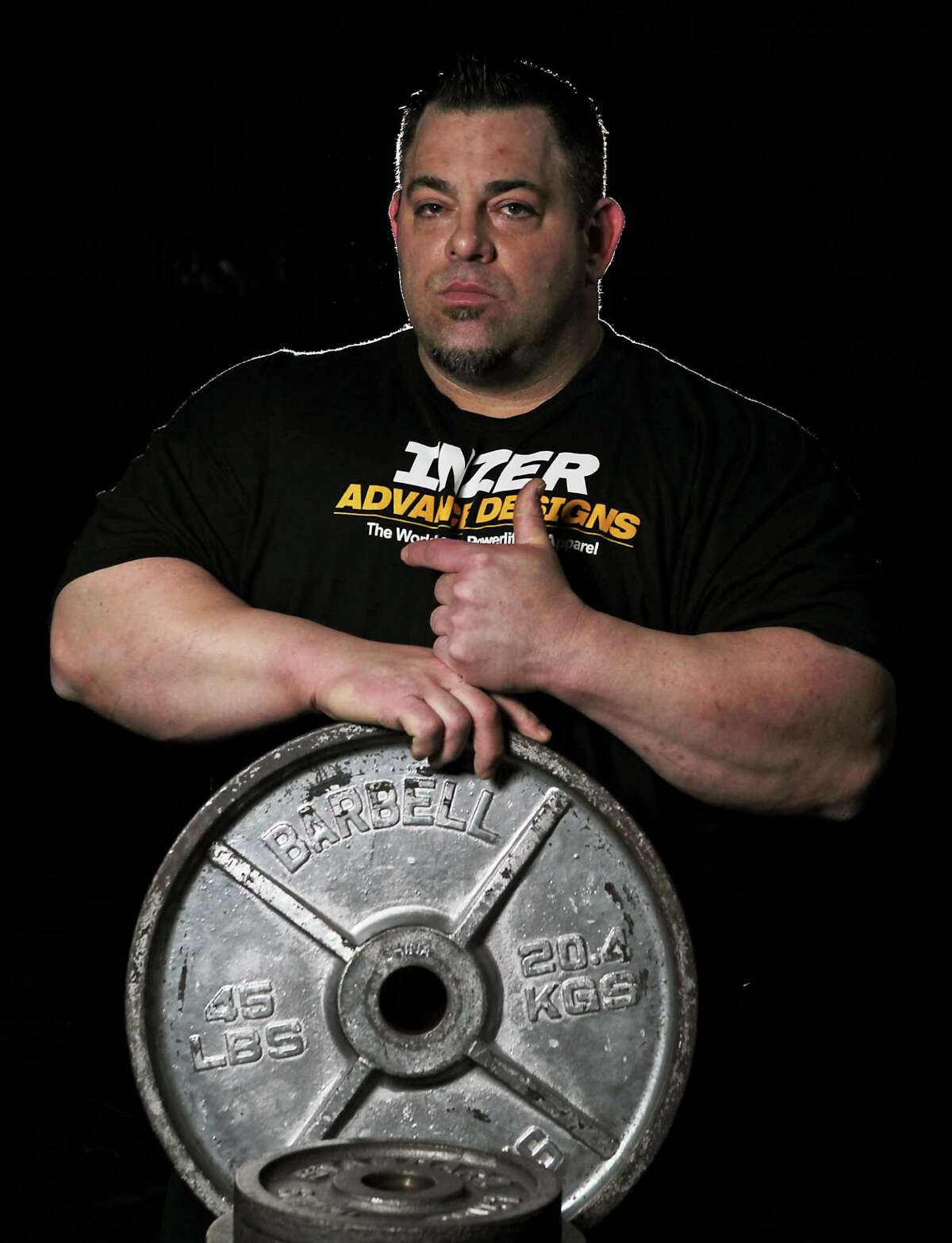 Monster Gym's Tiny Meeker, who recently became the first man in the world to bench press over 1,100 pounds, poses for a portrait on Sunday in Kingwood.
