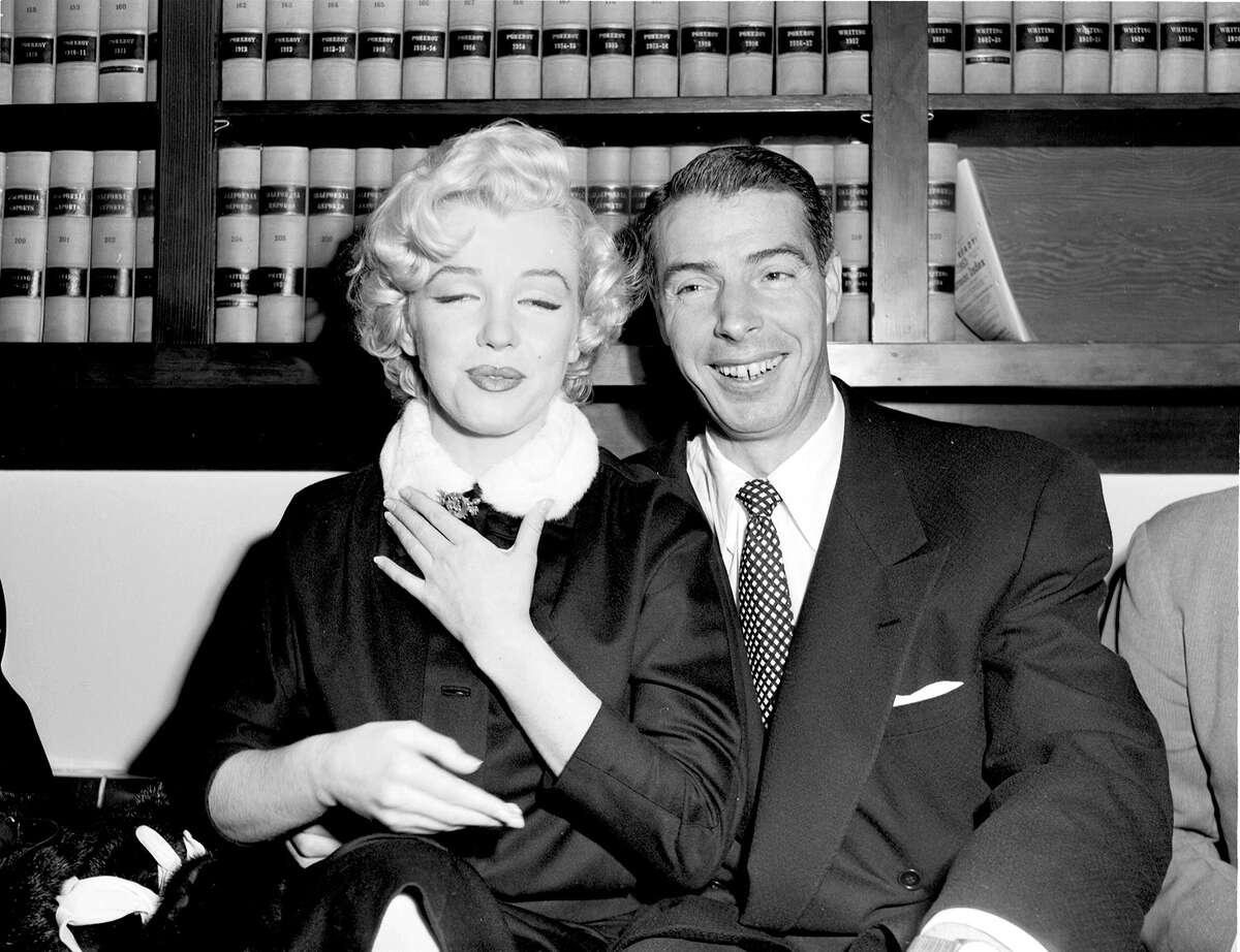 Marilyn Monroe and Joe DiMaggio in the judge's chambers before their marriage on January 14, 1954.