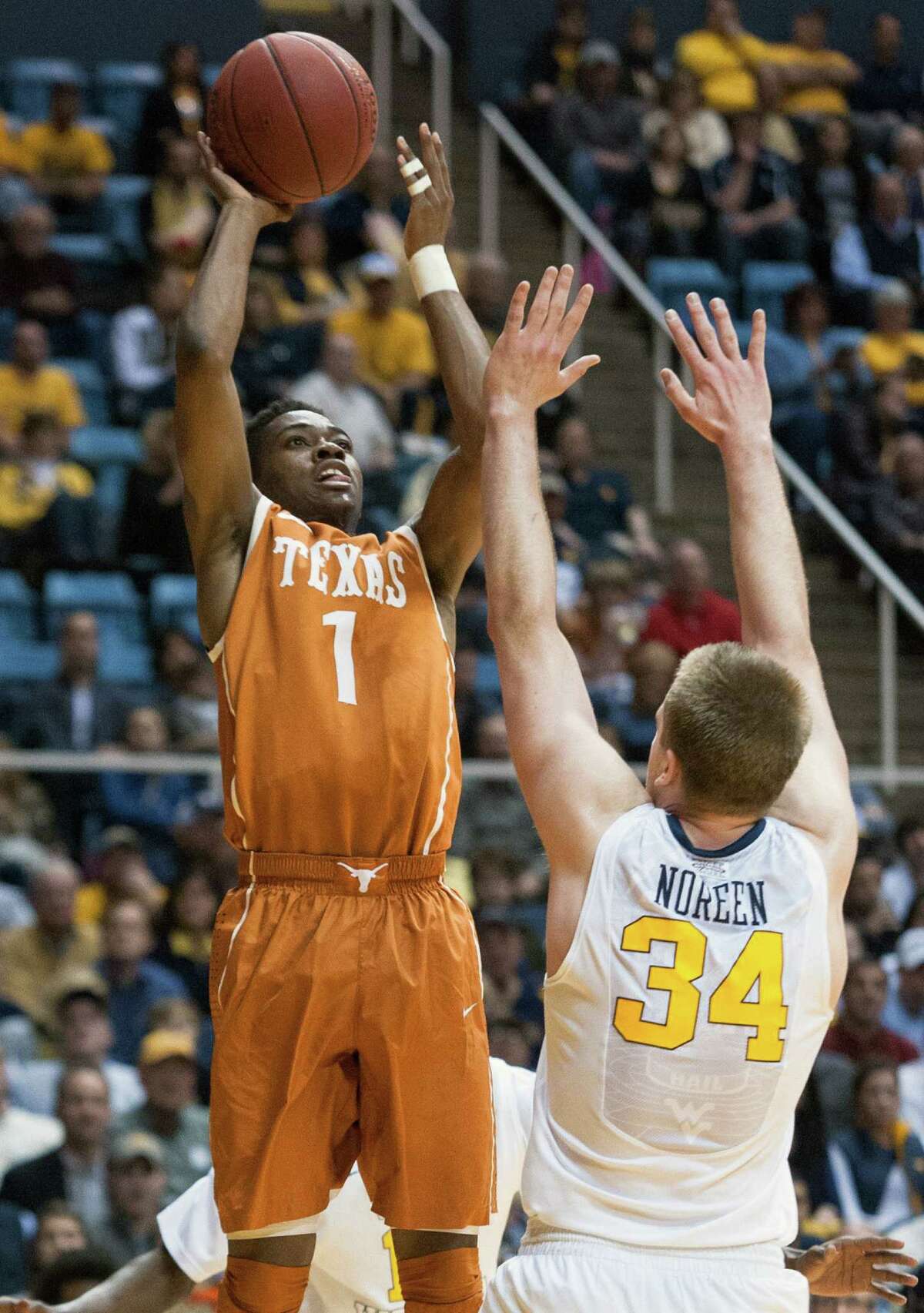 Isaiah Taylor of Texas prepares to put up a shot over West Virginia's Kevin Noreen during the first half. Taylor finished the game with 10 points and four assists.
