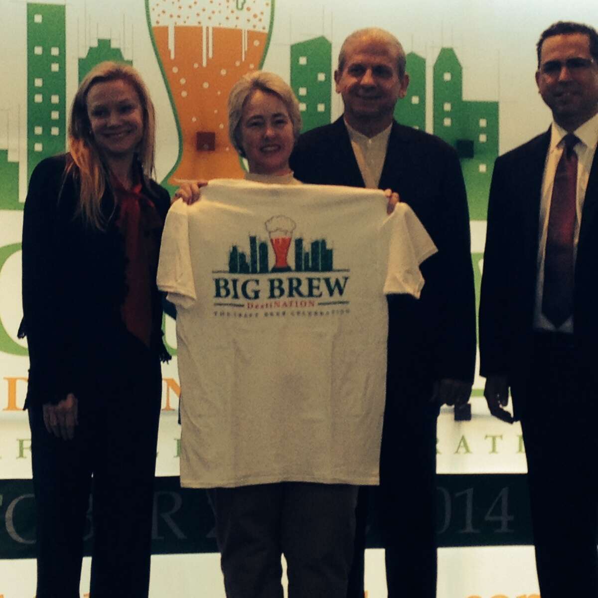 Mayor Annise Parker posed with a Big Brew T-shirt, flanked by Lisa Rydman of event sponsor Spec's and organizer Clifton McDerby of Food & Vine Time Productions.