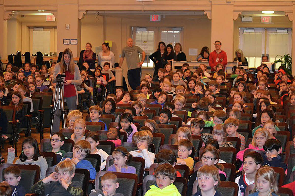 Kings Highway School students assembled to hear announcement of the "One School, One Book" selection -- "The Cricket in Times Square" -- for schoolwide reading activities.