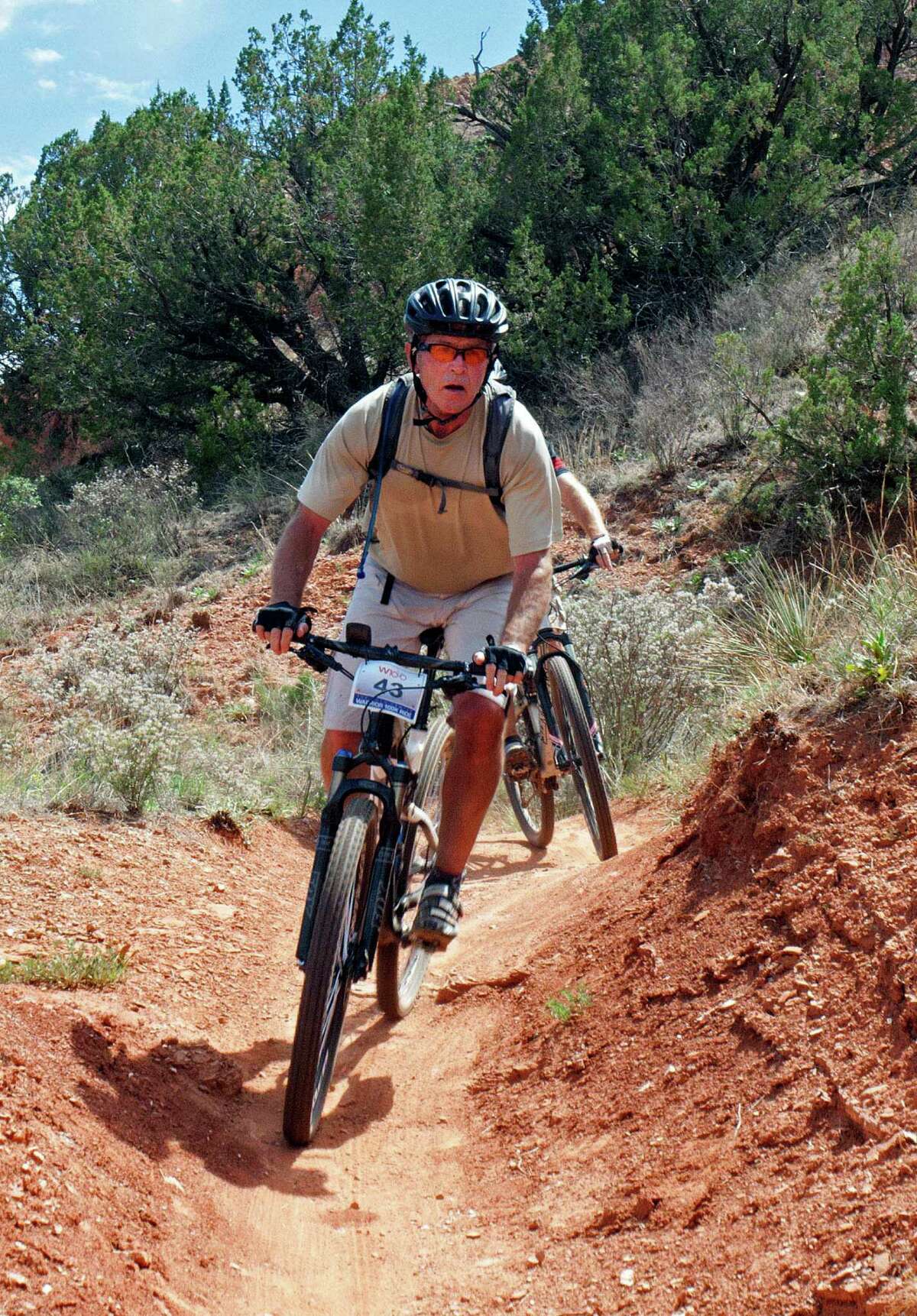 Former President George W. Bush leads the way along one of the many biking trails at Palo Duro Canyon State Park.