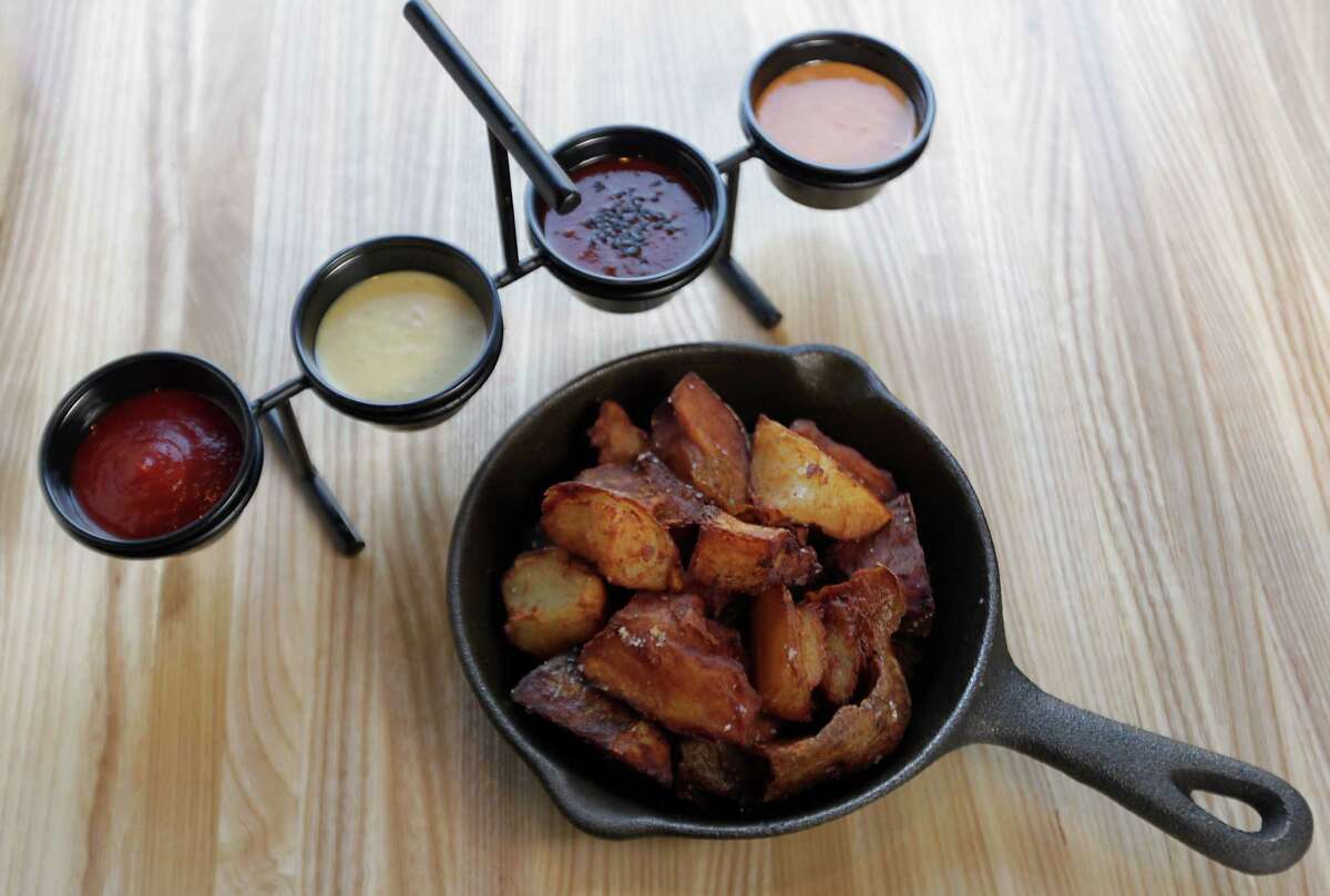 The signature Baked & Fried Idaho potato fries with a flight of four dipping sauces at Fielding's Wood Grill are not to be missed.