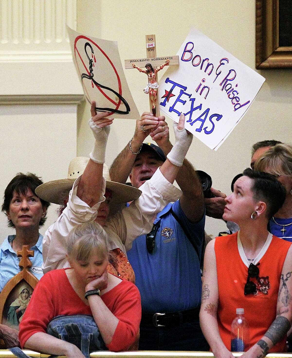 Abortion bill protesters, in orange, and those for the bill in blue, gather at the State Capitol for the start of the second special session, Monday, July 1, 2013.
