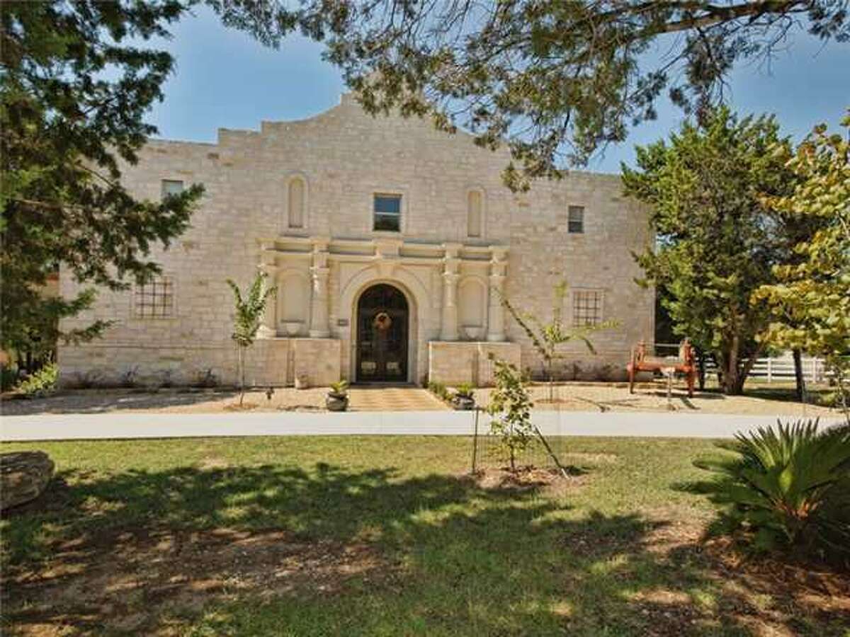 This is a house for those with true 'Texas spirit.' Modeled about the historic Alamo and located at 500 Contrails Way, Spicewood, TX 78669, this house boasts a waterfront view with its own dock. Rustic on the outside, it's far more luxurious on the inside than the real Alamo. The 6,553-square-foot home boasts four bedrooms, five bathrooms, a home theater and beautiful views from the second story porch - a better view than Rivercenter mall for sure. Need more info? The MLS# is 9996407. 