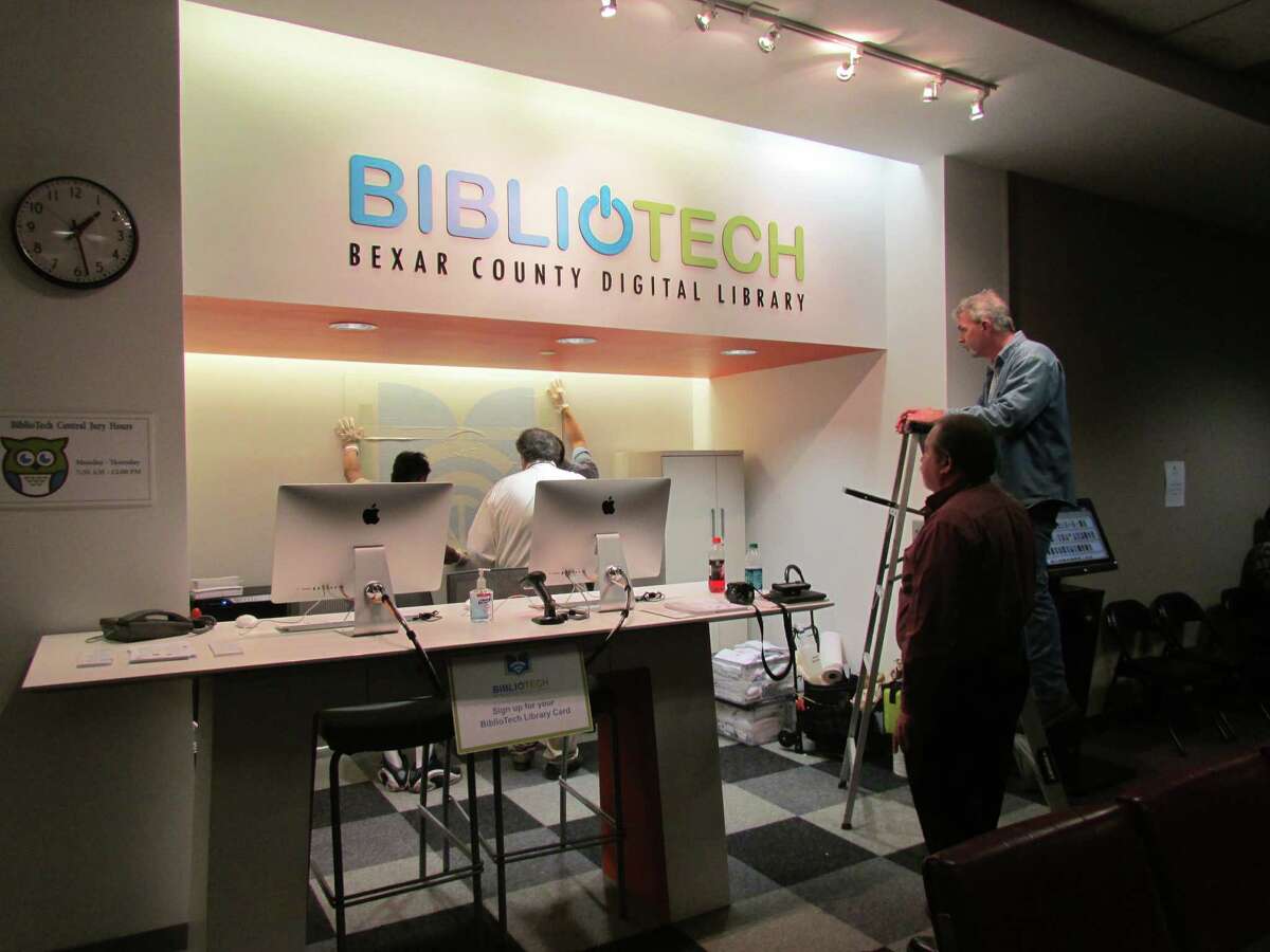 Bexar County employees put the final touches on the BiblioTech branch in the central jury room. Two employees will staff the counter, where county residents can register for a BiblioTech account and check out one of 200 electronic reading devices. There is also a kiosk on-site, where BiblioTech account holders can check out books.