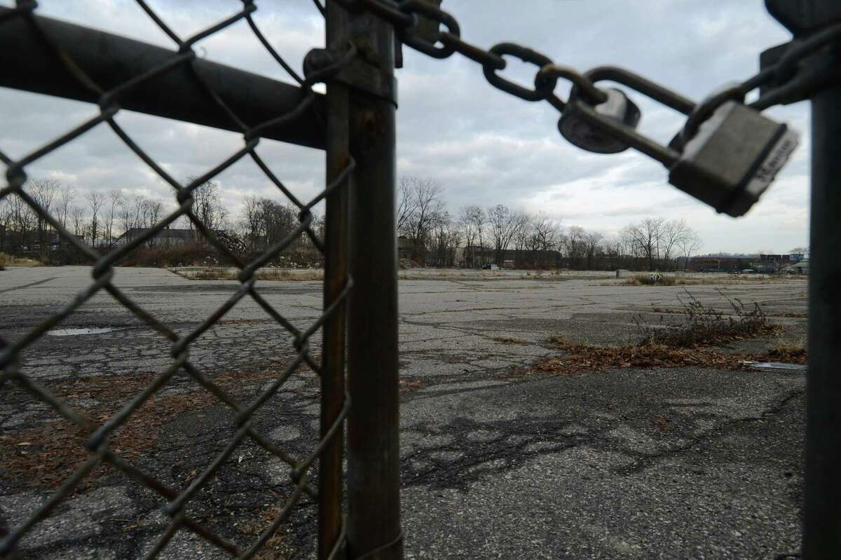 A lock keeps trespassers out of the abandoned Kennedy Place in Danbury, Conn. on Wednesday, Jan. 15, 2014. A developer just got a tax break to build 367 apartments in the vacant lot.