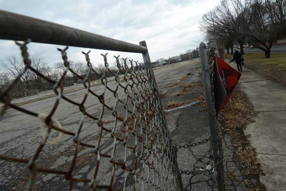 A fence surrounds the abandoned Kennedy Place in Danbury, Conn. on Wednesday, Jan. 15, 2014. A developer just got a tax break to build 367 apartments in the vacant lot.