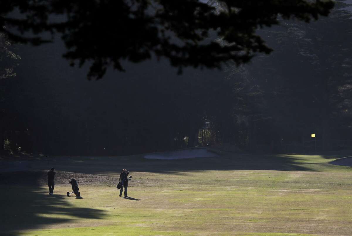 Golfers hit their approach shots towards the 3rd green at Sharp Park Golf Course in Pacifica, Calif. on Thursday, Jan. 16, 2014. Proposed improvements to a pump house and a cart path at the San Francisco city owned course worry environmentalists.