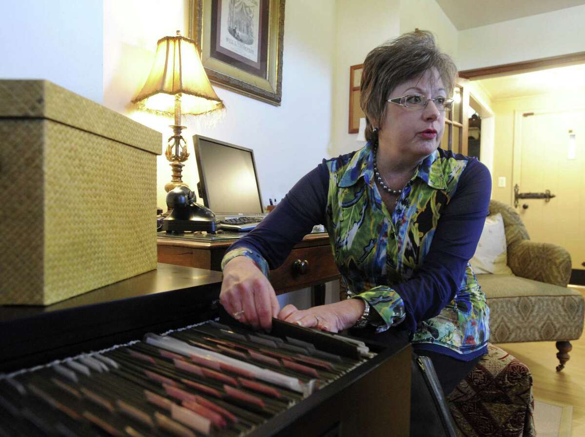 Kat Jacoby, president of Divine Organization, looks through files she helped organize in a client's home in Comfort.