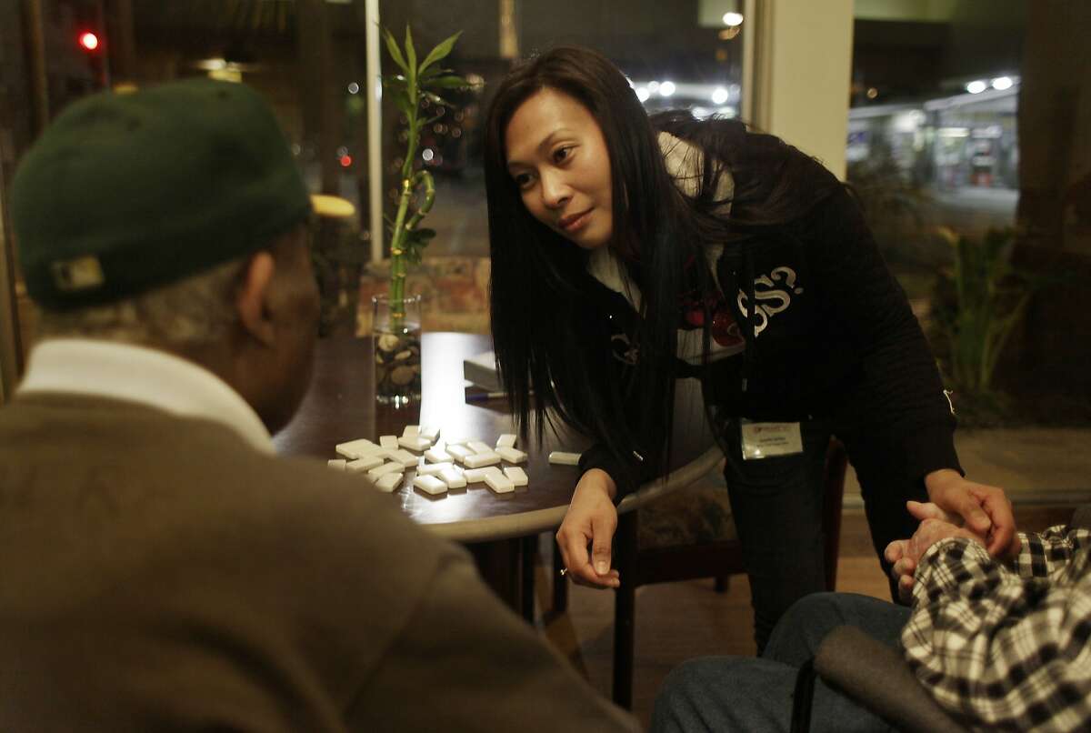 Janelle Ubilas (center), WoodPark medical technician, cares for residents at WoodPark while working an evening shift on Tuesday, December 10, 2013 in Oakland, Calif.