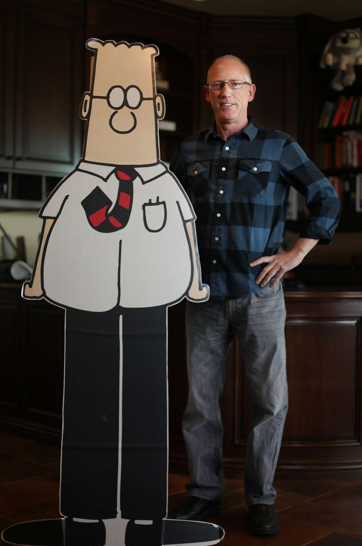 Scott Adams, cartoonist and author and creator of "Dilbert", poses for a portrait with a life-sized Dilbert cutout in his home office on Monday, January 6, 2014 in Pleasanton, Calif. Adams has published a new memoir "How to Fail at Almost Everything and Still Win Big: Kind of the Story of My Life".