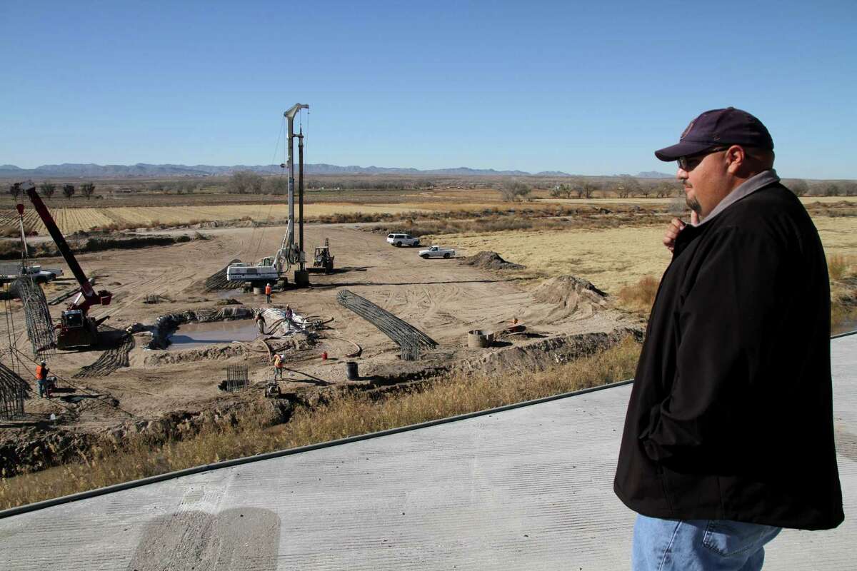 El Paso County Project engineer Fernie Hernandez watches as Mexican crews work on the bridge project. The U.S. part of the port of entry is nearly done.