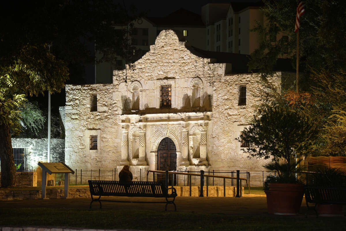 A visitor looks over the alamo which recently had new lighting intalled to illuminate the Shrine.
