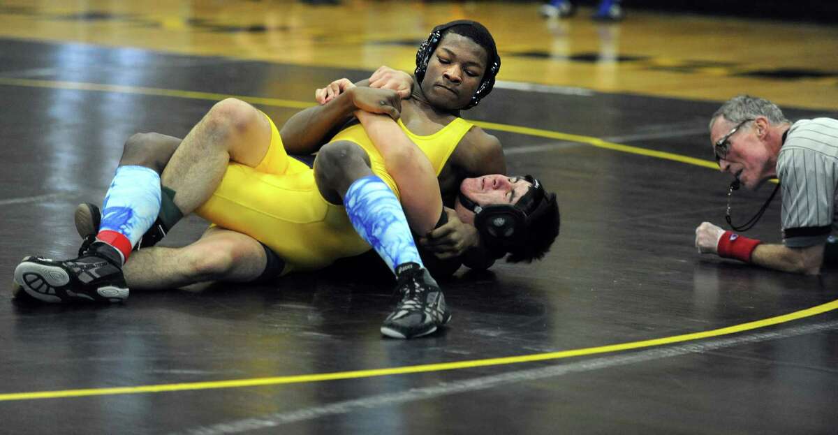 Harding's Xavier Bass, top, and East Haven's Jose Magana compete in the 170lb weight class during a wrestling invitational Saturday, Jan. 18, 2014, at Jonathan Law High School in Milford, Conn.