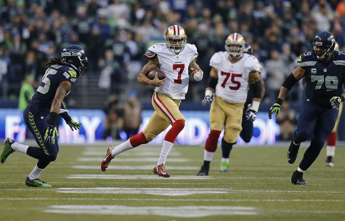 49ers quarterback Colin Kaepernick, (7) on a 58 yard run in the second quarter, as the San Francisco 49ers take on the Seattle Seahawks in the NFC Championship game at CenturyLink Field in Seattle, Washington on Sunday Jan. 19, 2014.