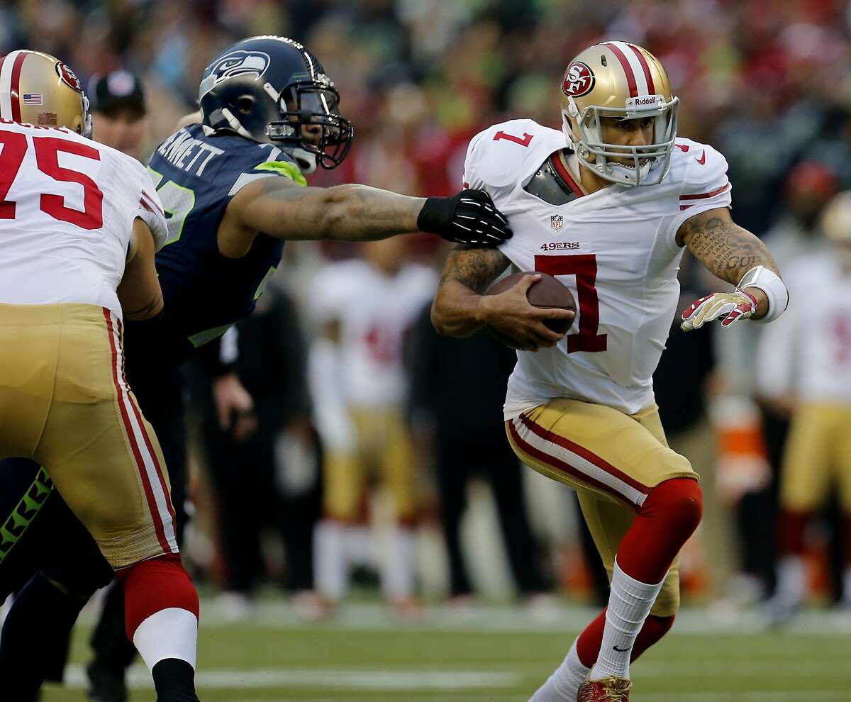 Colin Kaepernick (7) took off for a run in the first quarter. The San Francisco 49ers meet the Seattle Seahawks for the NFC title at CenturyLink field in Seattle, Washington Sunday January 19, 2014.