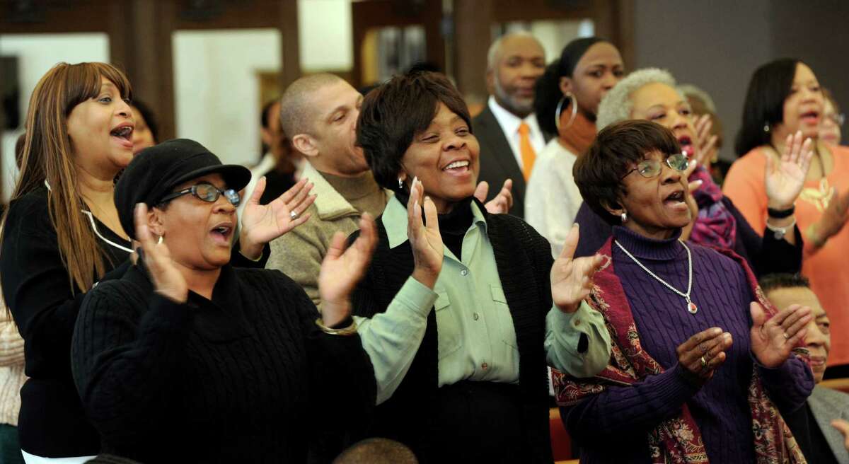 From left, Kim Brown, Carrie Anderson and Pearl Torian join in singing " Happy Birthday," Stevie Wonder's song first written to advocate for making King's birthday a holiday. New Hope Baptist Church in Danbury, Conn., holds it's 12th annual celebration honoring Dr. Martin Luther King Jr., Monday, January 20, 2014.