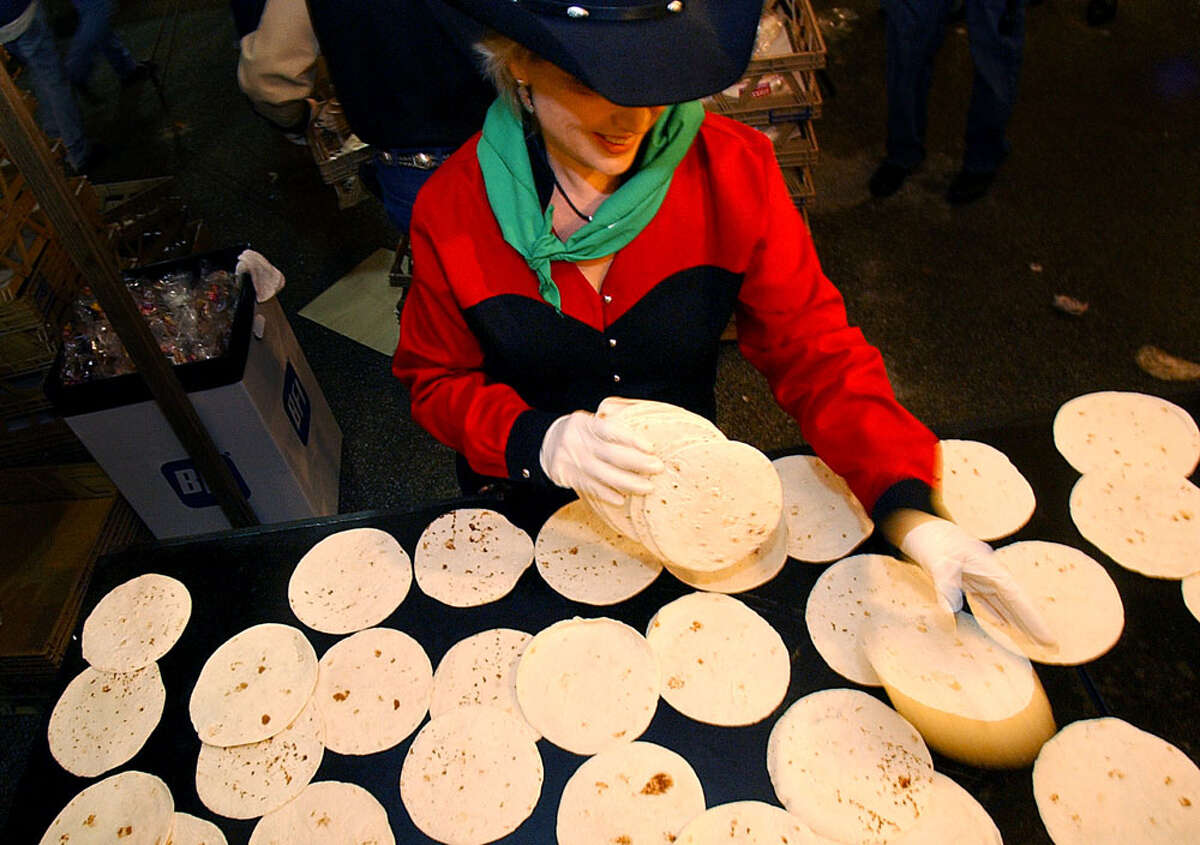 34,000 tortillas by Mission Foods Susie Henckel spreads out a stack of tortillas like a blackjack dealer as she helps prepare breakfast tacos at the annual Cowboy Breakfast at Crossroads Mall on Jan. 30, 2004.