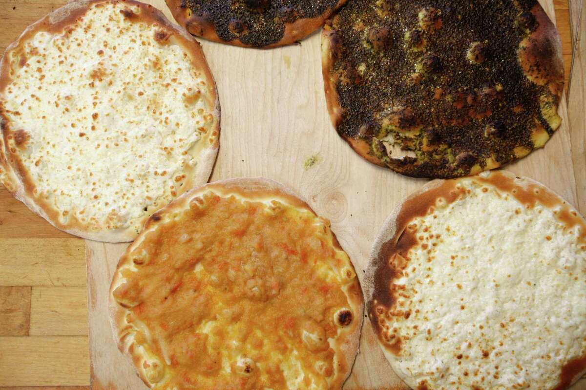 Cedars Bakery offers a variety of cheese bread, left, kafta, top, and za'atar pies.
