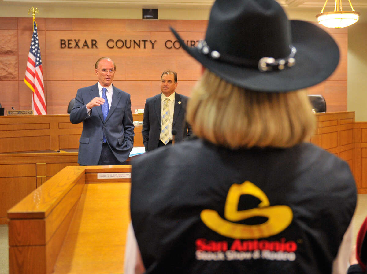 Bexar Country Judge Nelson Wolff (left) comments on the San Antonio Stock Show and Rodeo as its Ambassadors Chairperson Cindy Gidden (foreground) and Commissioner Sergio “Chico” Rodriguez listen.